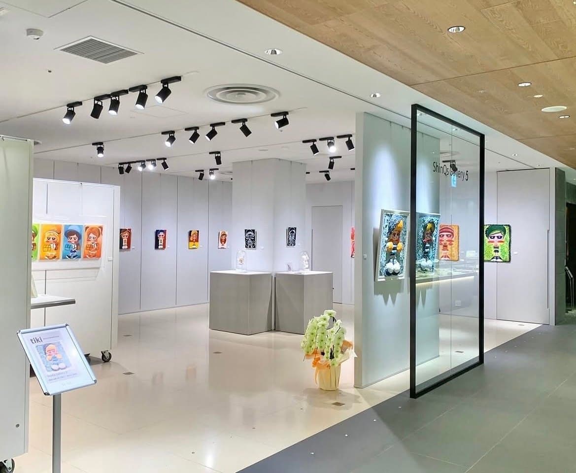 Inside the gallery: works on the white walls and columns